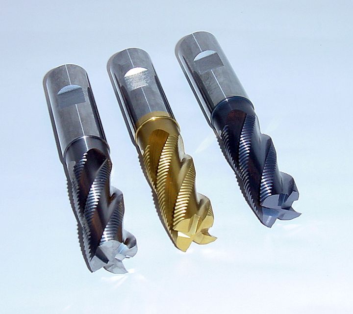 Three roughing end mills with serrated edges and different coatings