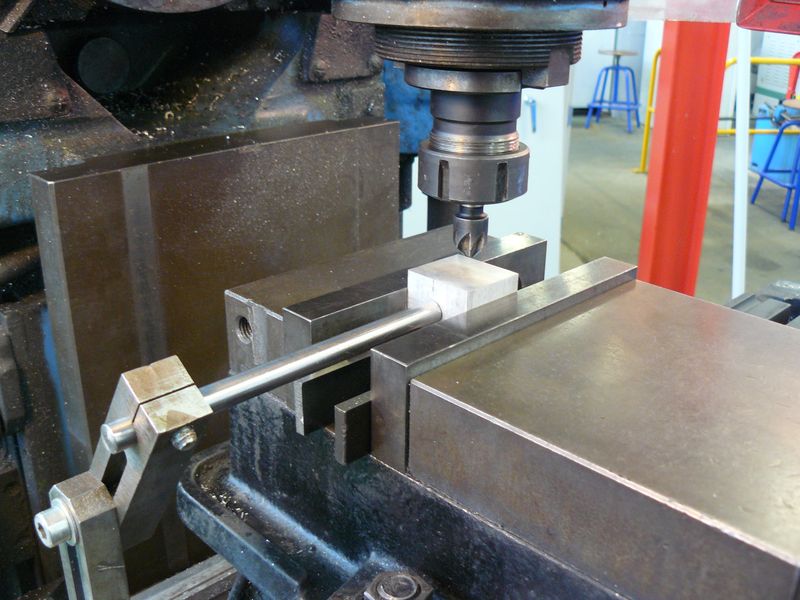 Part clamped in a milling machine vise against the fixed jaw